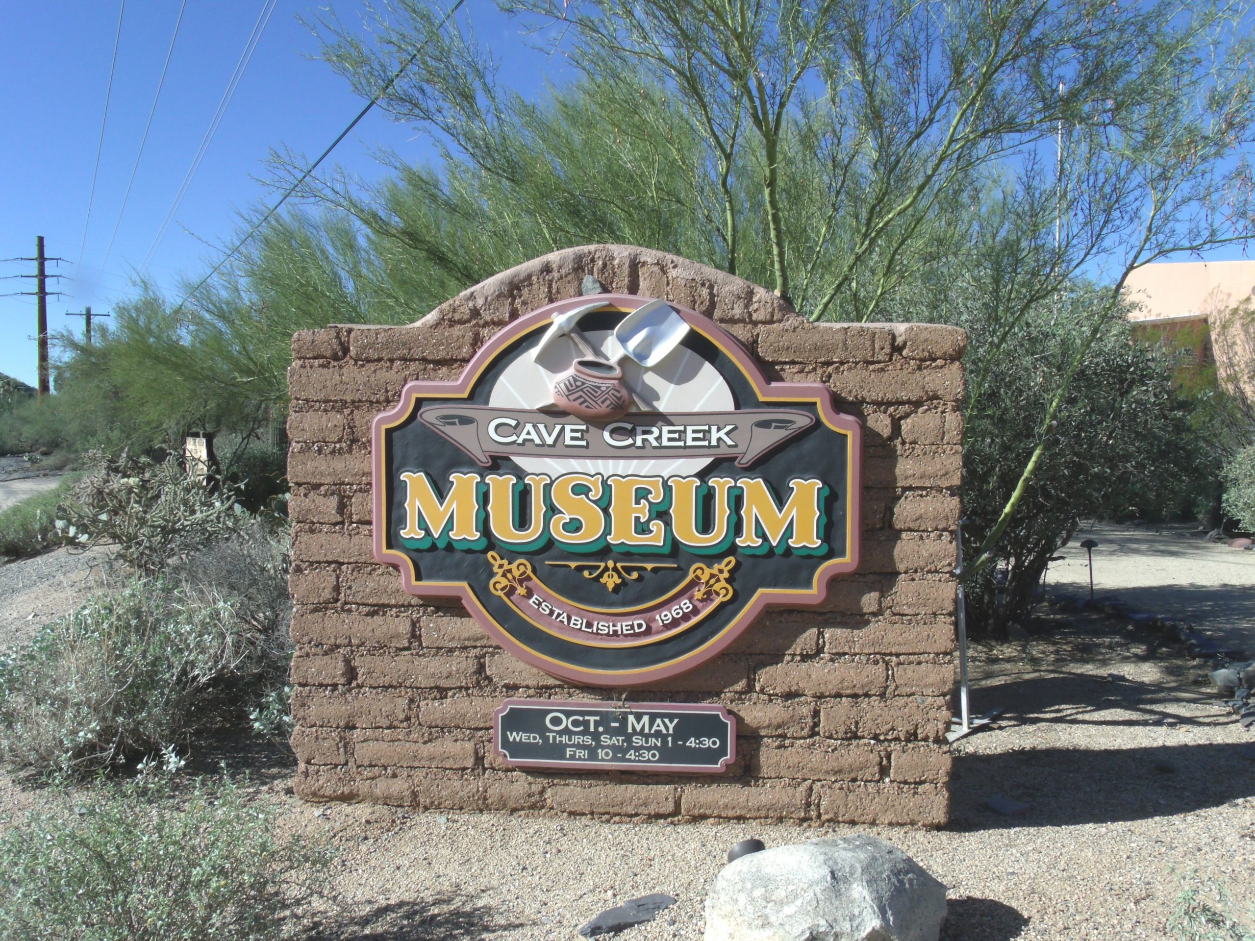 Cave Creek Museum entrance sign surrounded by desert landscaping