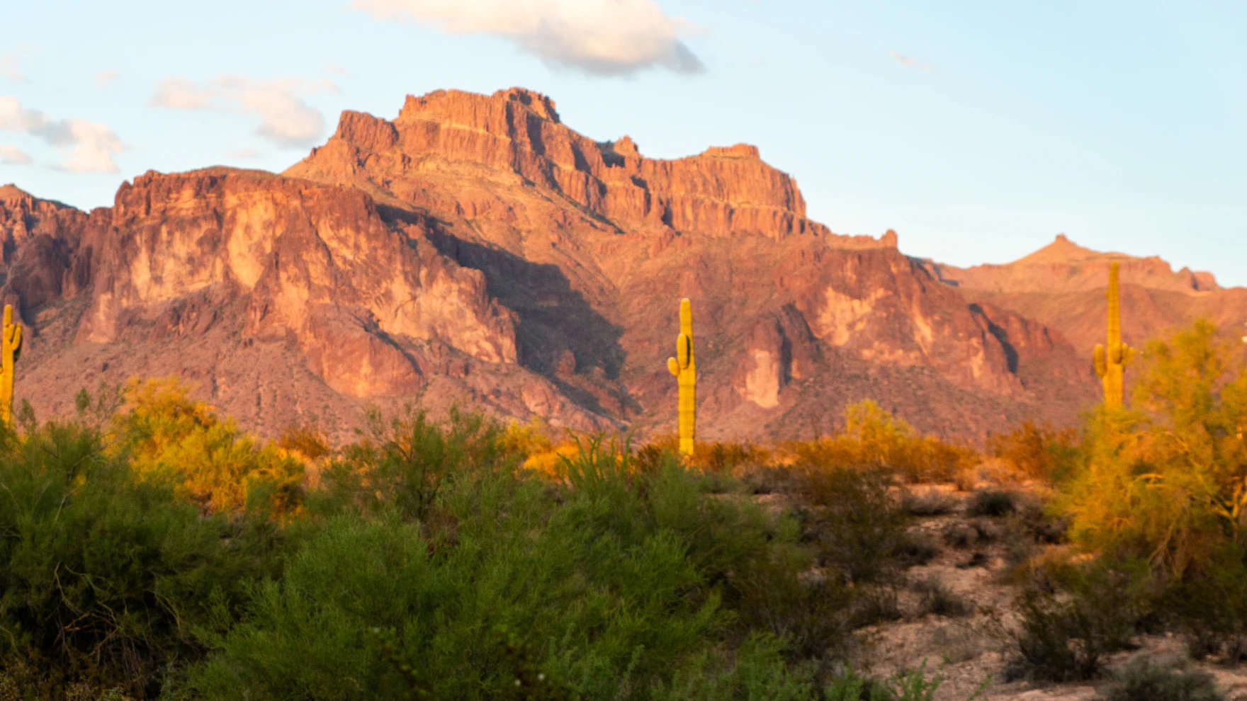 Cougar shaped shadow on the Superstition Mountains in Arizona at sunset.